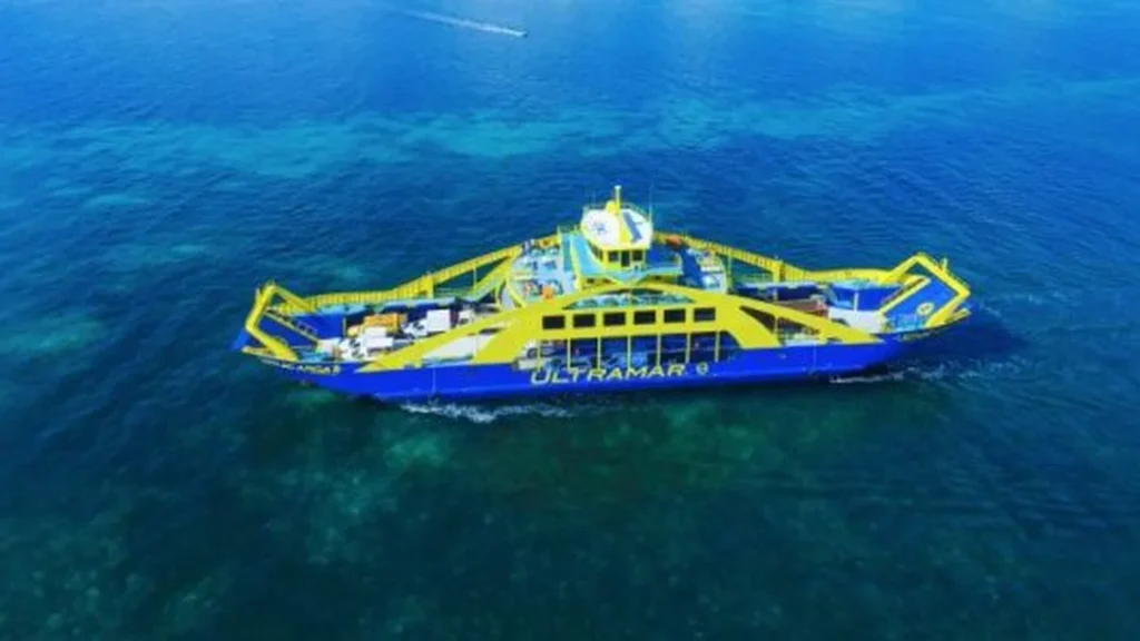 Passenger ferry seen from above in deep blue Caribbean water
