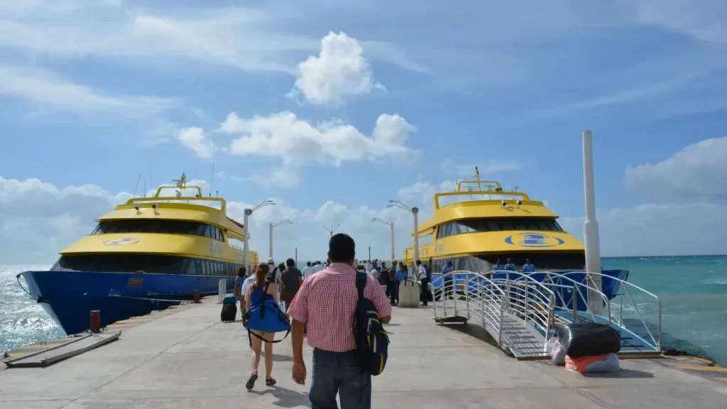 Passengers walking toward ferries at the Isla Mujeres dock