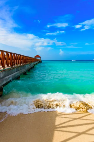 Wooden pier beside turquoise Caribbean water on Isla Mujeres
