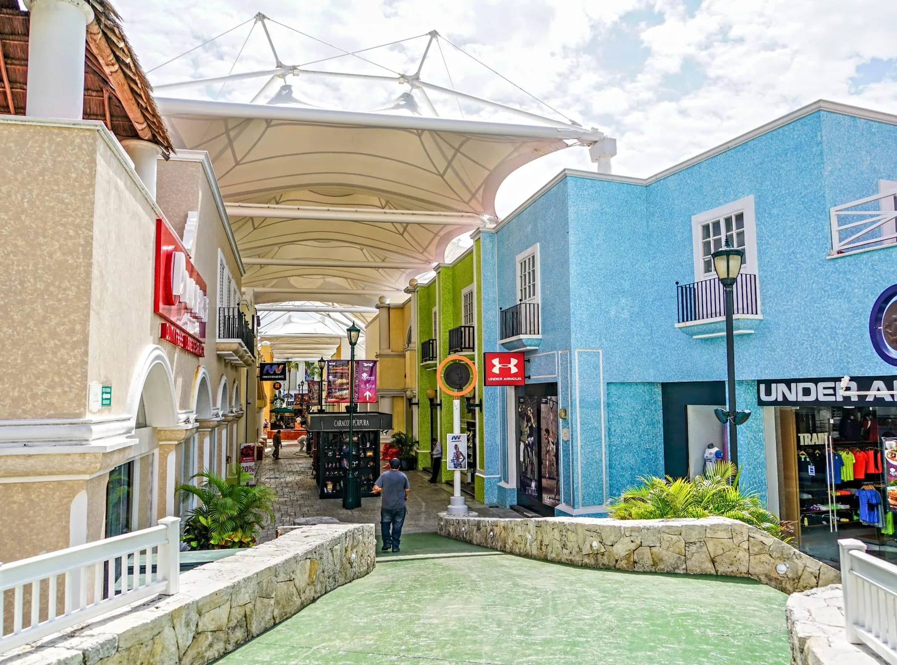 A colorful open-air shopping walkway in Cancún