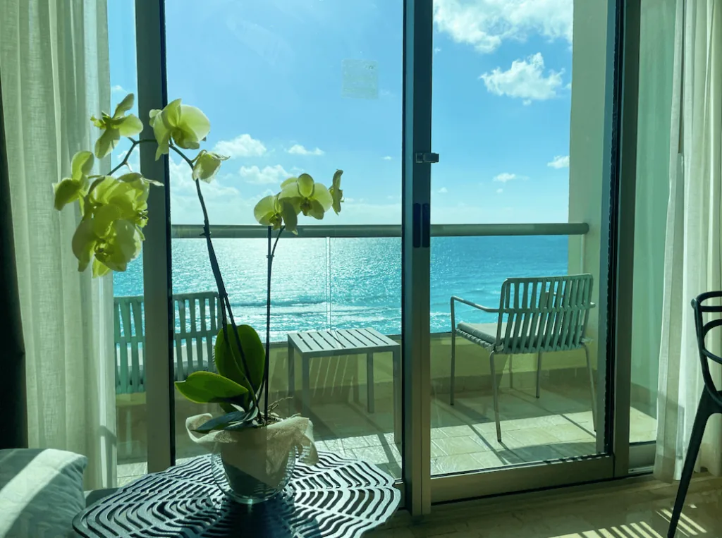 A simple oceanfront room looking toward bright Caribbean water