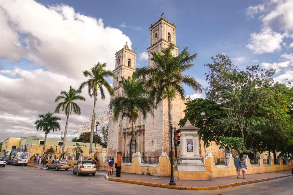 The cathedral of San Servacio framed by palms and a bright sky
