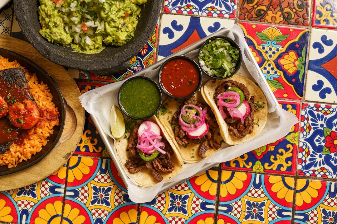 Table with Mexican dishes and guacamole